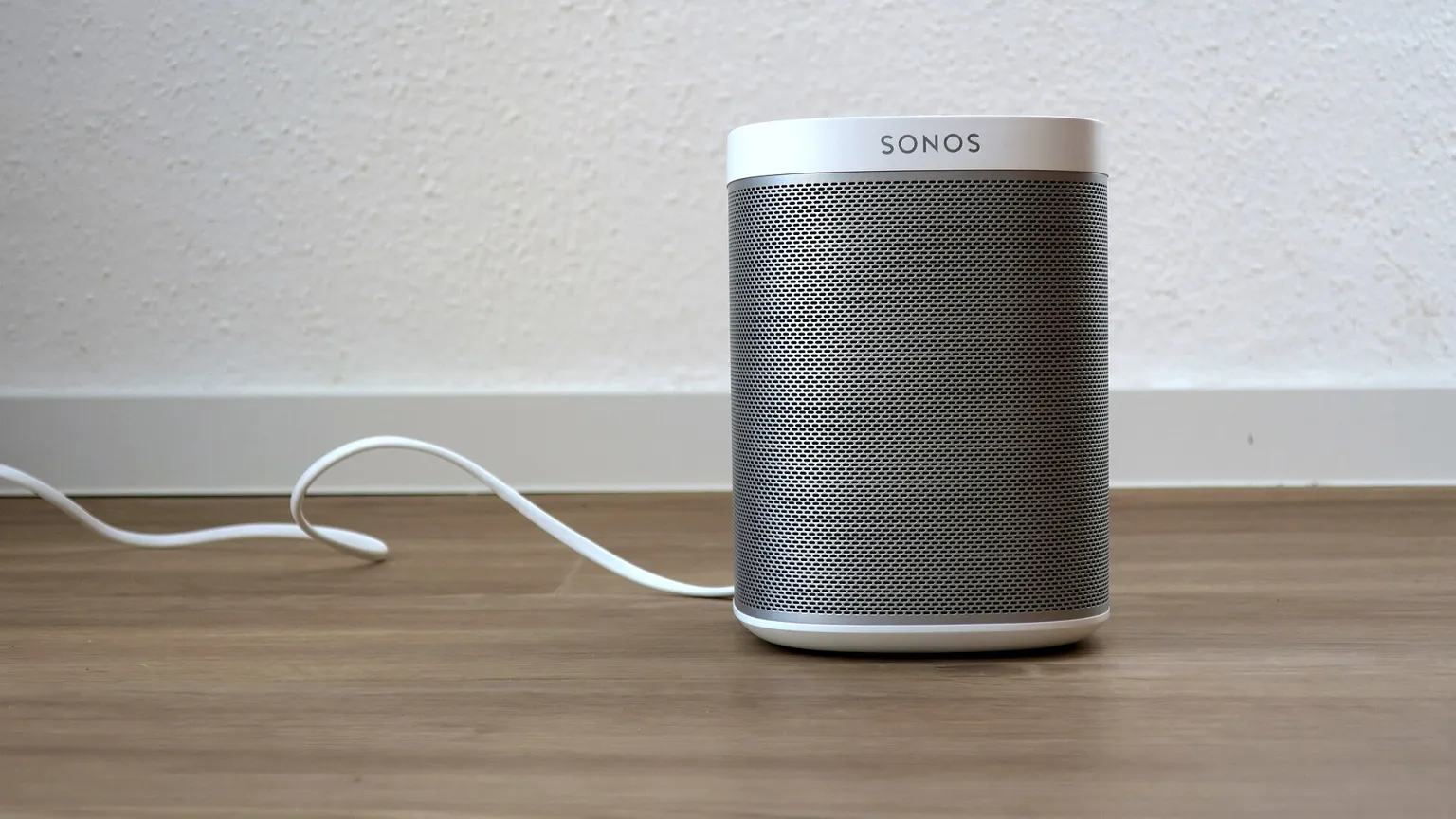 AI illustration: Wireless smart speaker on a wooden floor