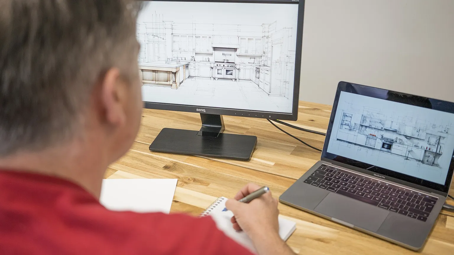 Designer working at a computer and laptop