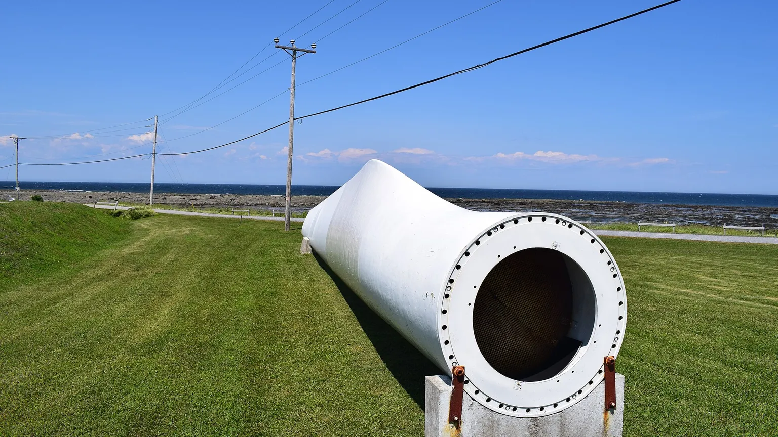 A wind-turbine blade on the ground at a wind farm